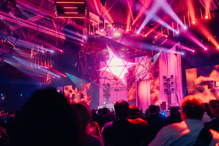 Slush main stage with a faceted sphere centrepiece lit by pink beams above a large crowd