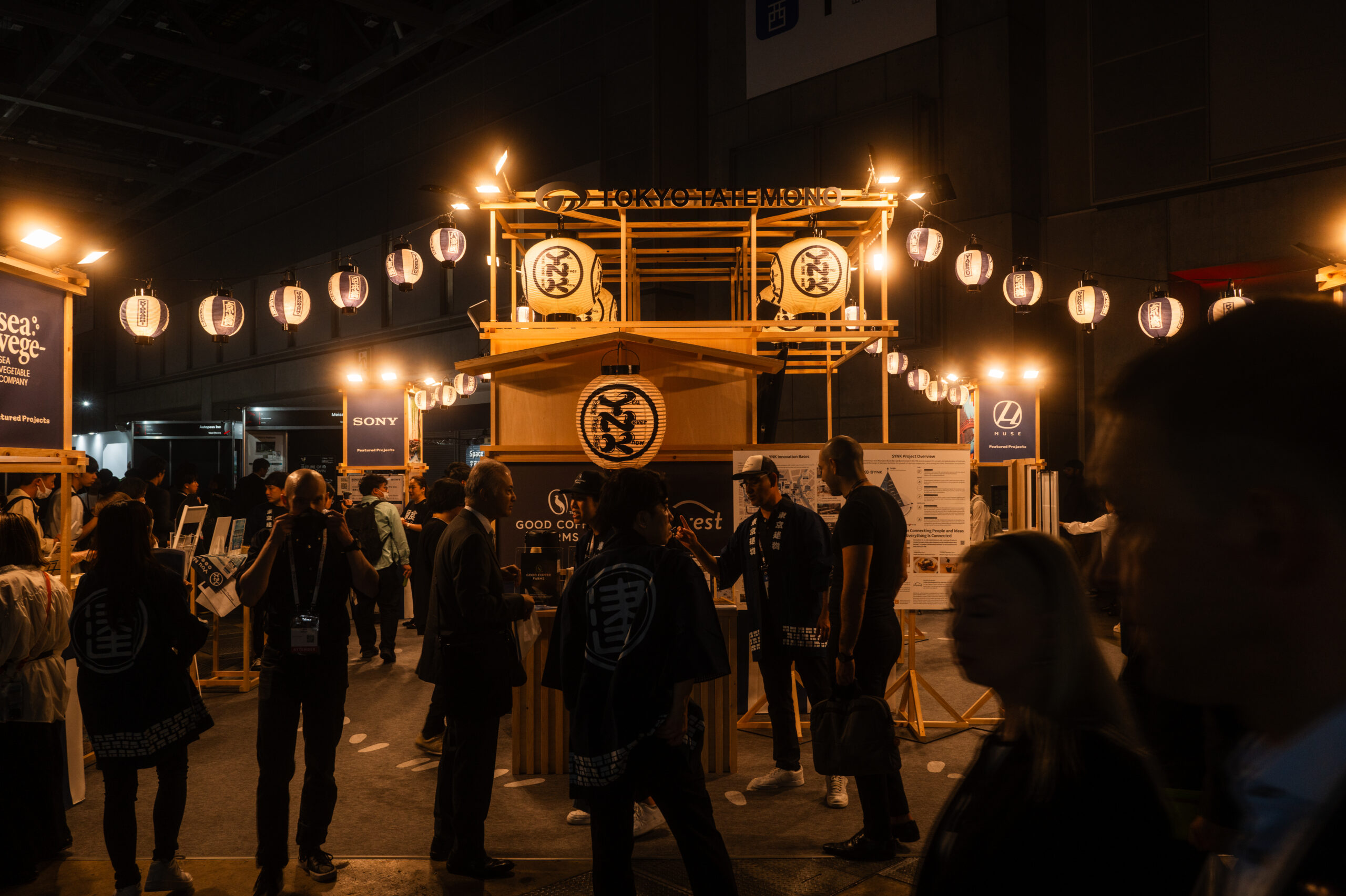 Traditional Japanese festival float and paper lanterns among attendees in happi coats at SusHi Tech